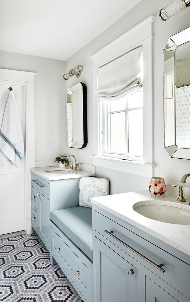 Inspiration for a beach style bathroom in DC Metro with recessed-panel cabinets, blue cabinets, grey walls, mosaic tile floors, an undermount sink, multi-coloured floor and white benchtops.