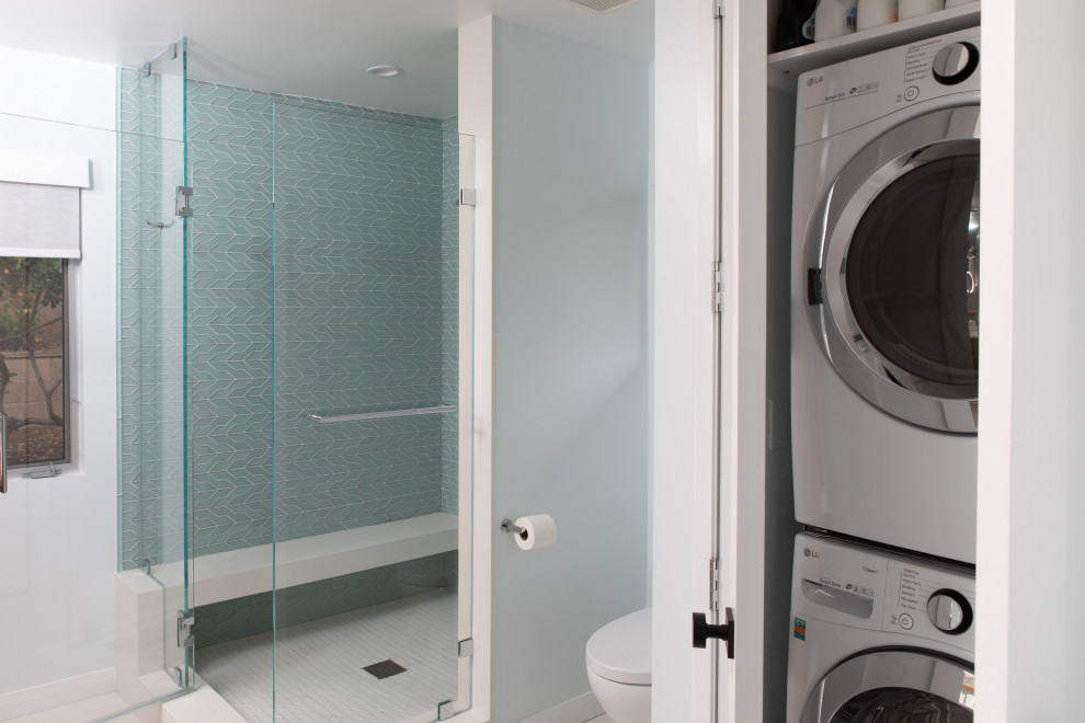 Ispirazione per un ripostiglio-lavanderia minimalista di medie dimensioni con pavimento con piastrelle in ceramica, lavatrice e asciugatrice a colonna e pavimento bianco