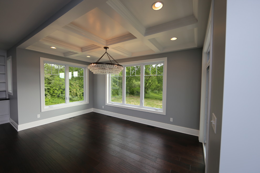 Photo of a large arts and crafts separate dining room in Chicago with grey walls, dark hardwood floors and brown floor.