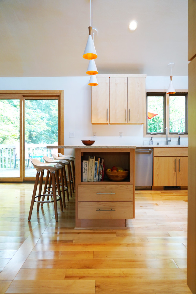 Design ideas for a mid-sized midcentury eat-in kitchen in Other with a drop-in sink, flat-panel cabinets, medium wood cabinets, quartz benchtops, blue splashback, stainless steel appliances, light hardwood floors, a peninsula and white benchtop.