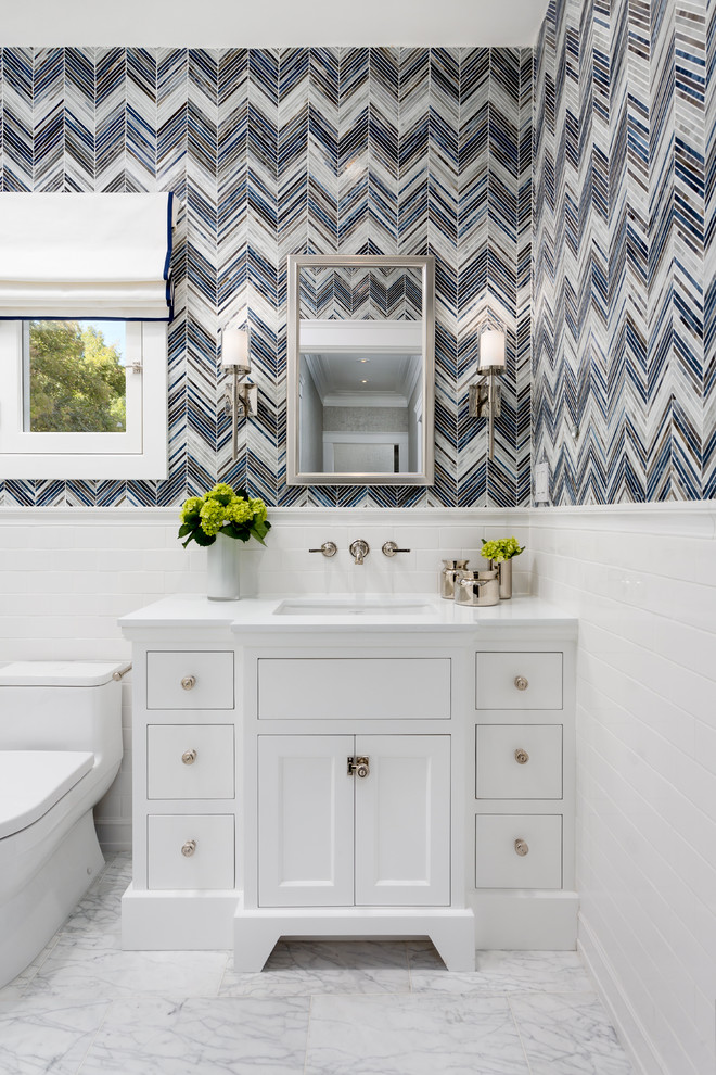 Small traditional 3/4 bathroom in Los Angeles with recessed-panel cabinets, white cabinets, a one-piece toilet, glass tile, blue walls, marble floors, an undermount sink and engineered quartz benchtops.