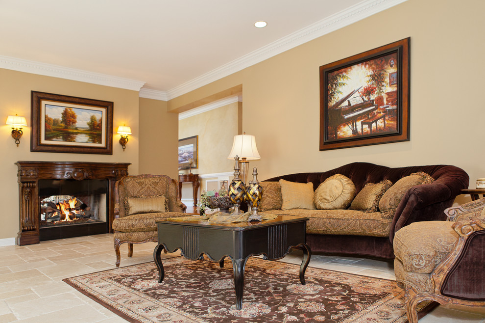 Photo of a mid-sized traditional enclosed living room in Dallas with beige walls, travertine floors, a standard fireplace, a wood fireplace surround, no tv and beige floor.