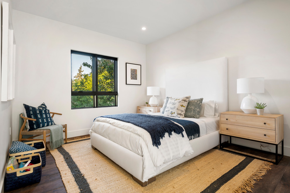 Design ideas for a mid-sized beach style guest bedroom in Los Angeles with white walls, light hardwood floors and brown floor.