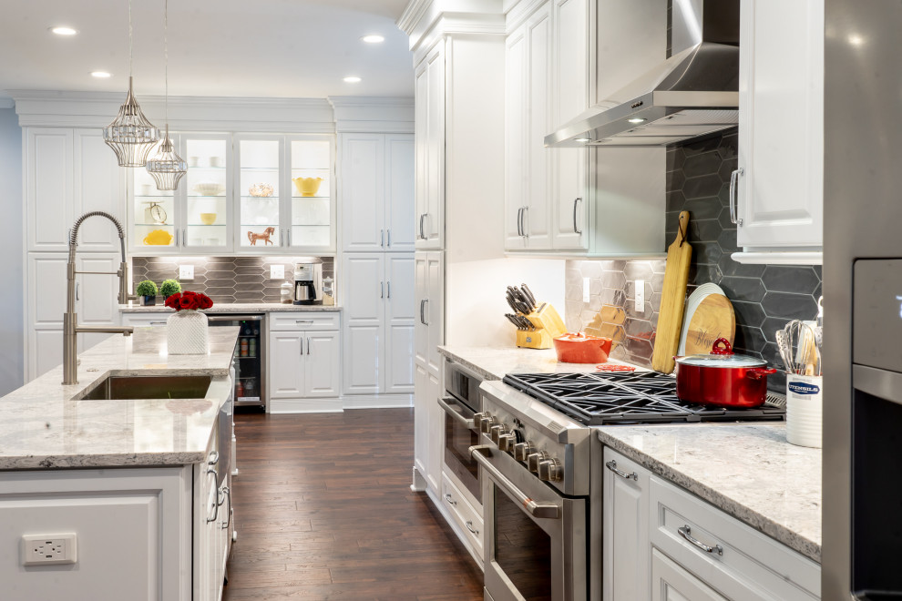 Example of a large transitional single-wall brown floor eat-in kitchen design in Atlanta with a farmhouse sink, raised-panel cabinets, white cabinets, quartz countertops, gray backsplash, ceramic backsplash, stainless steel appliances, an island and multicolored countertops