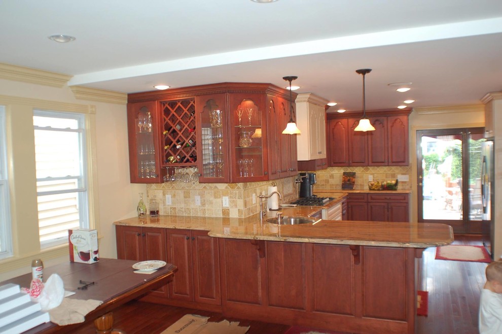 Inspiration for a large kitchen pantry remodel with recessed-panel cabinets and medium tone wood cabinets