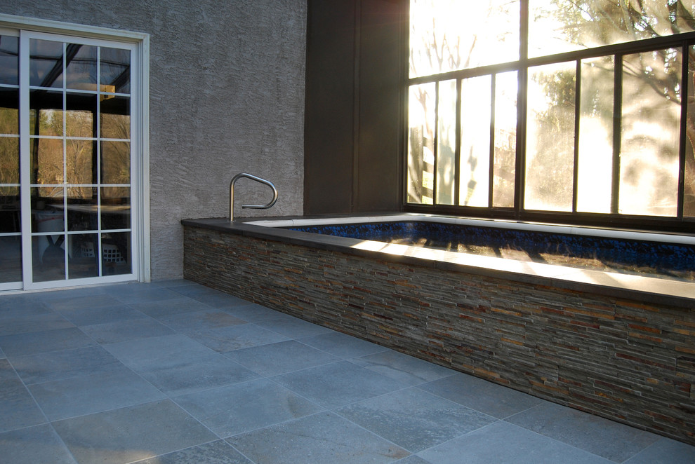Photo of a mid-sized contemporary indoor rectangular pool in Philadelphia with tile.