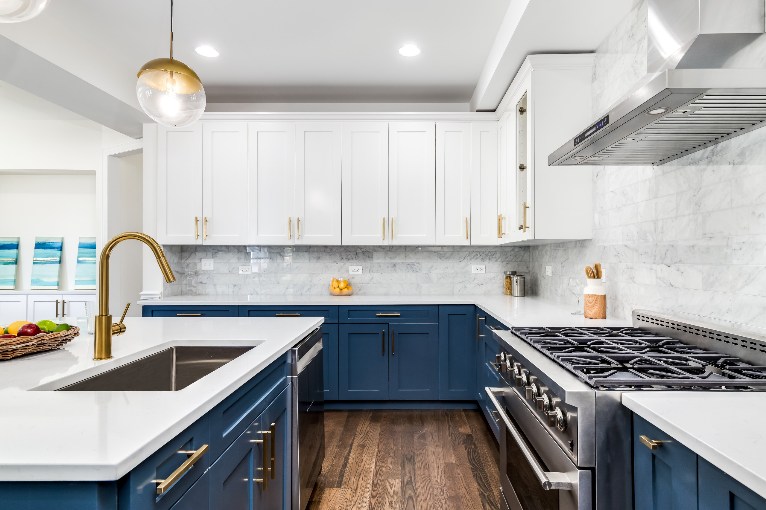 Navy and blue kitchen with brass accents and marble countertops by Case  Design/Remodeling i…