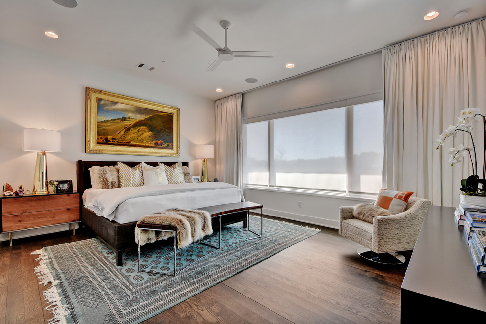 Design ideas for a transitional master bedroom in Austin with medium hardwood floors and white walls.