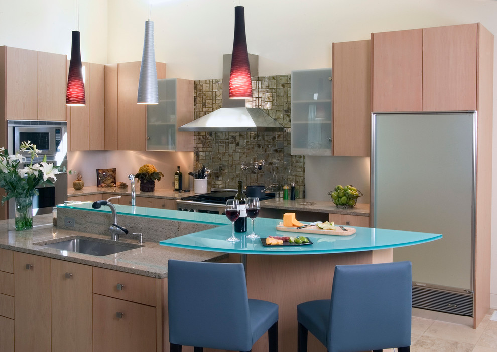 Design ideas for a large contemporary l-shaped open plan kitchen in Chicago with an undermount sink, flat-panel cabinets, light wood cabinets, glass benchtops, multi-coloured splashback, ceramic splashback, stainless steel appliances, limestone floors and with island.