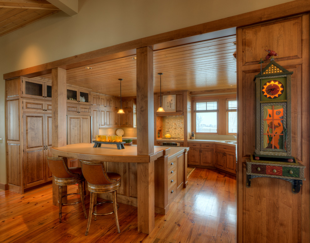 Design ideas for a mid-sized country u-shaped separate kitchen in Seattle with raised-panel cabinets, medium wood cabinets, multi-coloured splashback, panelled appliances, an undermount sink, tile benchtops, medium hardwood floors, with island and brown floor.