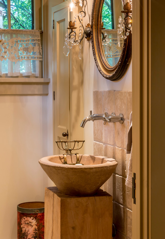 Country powder room in Chicago with a vessel sink, beige tile, stone tile and white walls.