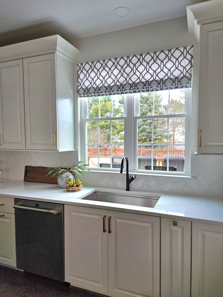 Inspiration for a large transitional u-shaped medium tone wood floor eat-in kitchen remodel in DC Metro with an undermount sink, raised-panel cabinets, white cabinets, quartz countertops, white backsplash, ceramic backsplash, stainless steel appliances, an island and white countertops
