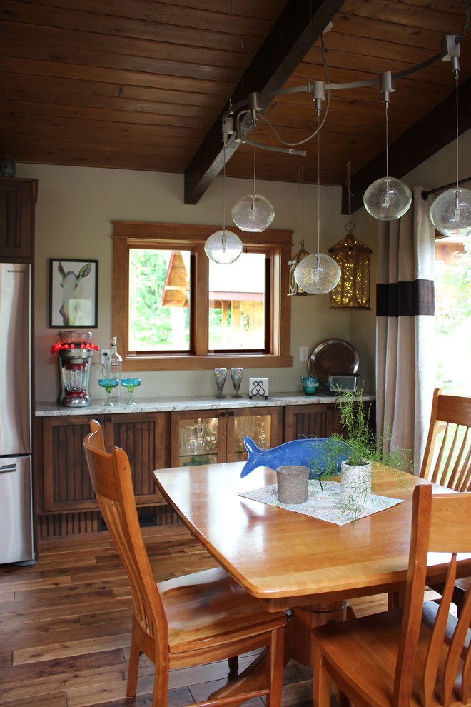 Eat-in kitchen - mid-sized rustic l-shaped light wood floor eat-in kitchen idea with a drop-in sink, dark wood cabinets, granite countertops, beige backsplash, stainless steel appliances and an island