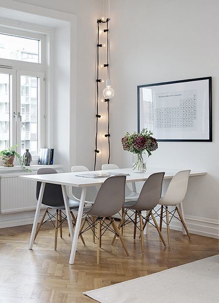Scandinavian dining room in Other with white walls and medium hardwood floors.