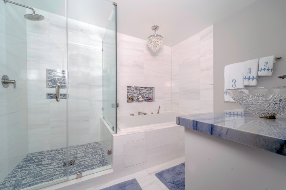 This is an example of a large contemporary kids bathroom in Los Angeles with glass-front cabinets, white cabinets, a drop-in tub, a shower/bathtub combo, a wall-mount toilet, gray tile, marble, grey walls, marble floors, a vessel sink, marble benchtops, white floor, a hinged shower door and blue benchtops.
