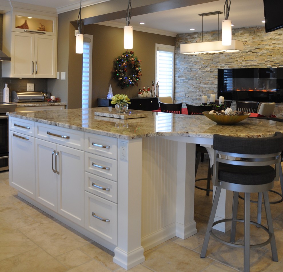Example of a large transitional l-shaped ceramic tile open concept kitchen design in Ottawa with an undermount sink, shaker cabinets, beige cabinets, granite countertops, glass tile backsplash, stainless steel appliances and an island