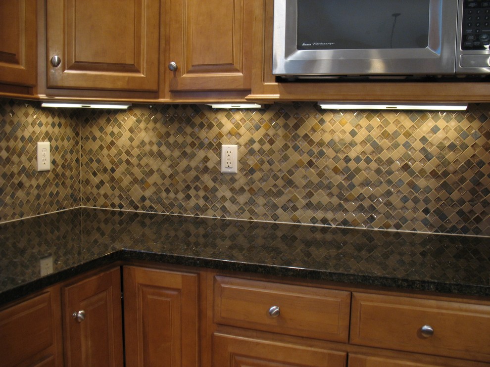 Transitional eat-in kitchen photo in Boston with granite countertops, multicolored backsplash, stone tile backsplash and an island