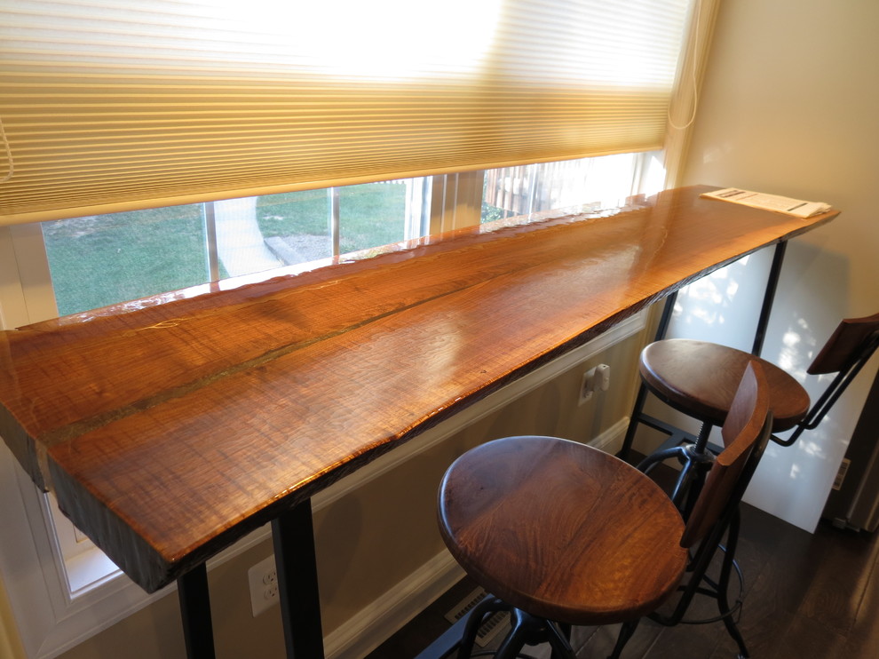 Inspiration for a large transitional galley dark wood floor and brown floor kitchen remodel with a double-bowl sink, raised-panel cabinets, white cabinets, granite countertops, white backsplash, porcelain backsplash, stainless steel appliances and an island
