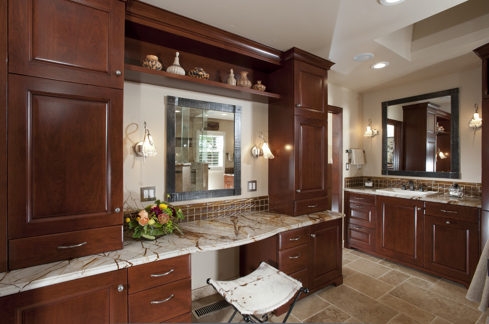 Large traditional master bathroom in San Francisco with a drop-in sink, raised-panel cabinets, dark wood cabinets, marble benchtops, a corner shower, beige tile, stone tile, beige walls, travertine floors, beige floor, a hinged shower door, a built-in vanity, a one-piece toilet, multi-coloured benchtops and a double vanity.