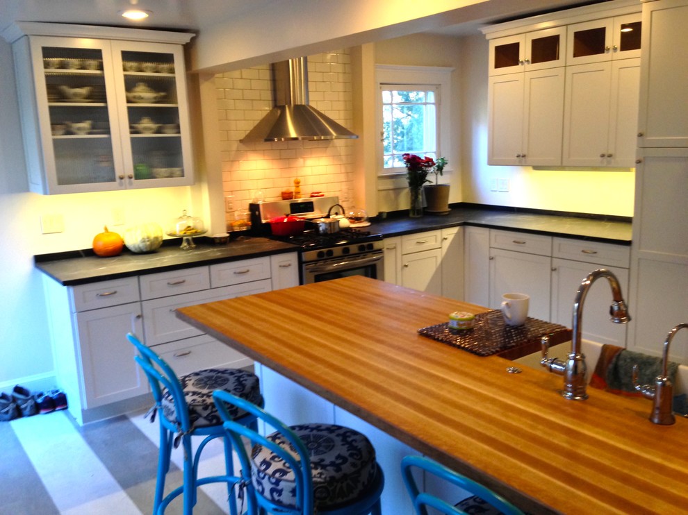 Large transitional cork floor kitchen photo in Baltimore with a farmhouse sink, flat-panel cabinets, white cabinets, wood countertops, stainless steel appliances and a peninsula