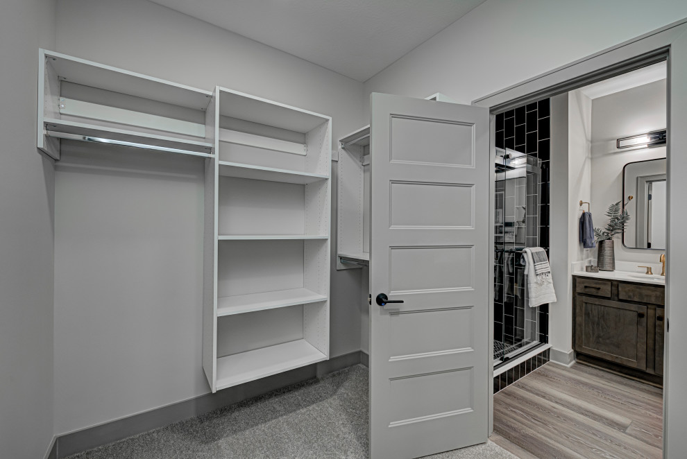 Mid-sized contemporary gender-neutral storage and wardrobe in Indianapolis with open cabinets, carpet, grey cabinets and grey floor.