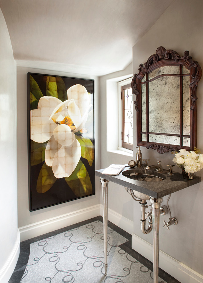This is an example of a transitional powder room in San Francisco with an undermount sink and grey walls.