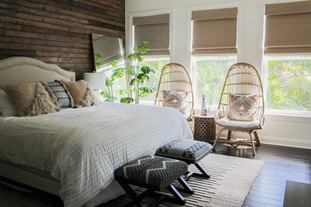 Large beach style master bedroom in Tampa with white walls, dark hardwood floors, brown floor and wood walls.