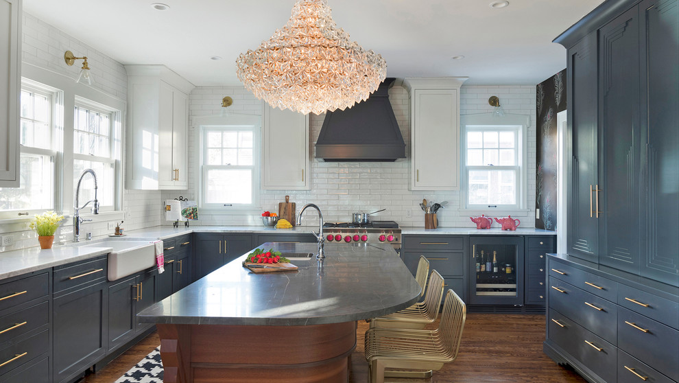 Inspiration for an eclectic u-shaped separate kitchen in Minneapolis with grey cabinets, marble benchtops, with island, a farmhouse sink, white splashback, subway tile splashback, medium hardwood floors, brown floor, recessed-panel cabinets and grey benchtop.