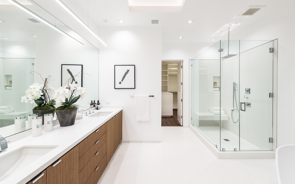 Inspiration for a large contemporary master bathroom in Orange County with flat-panel cabinets, medium wood cabinets, a corner shower, white tile, ceramic tile, white walls, ceramic floors, a drop-in sink and solid surface benchtops.