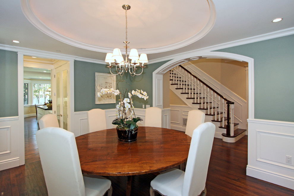 This is an example of a mid-sized traditional dining room in Los Angeles with dark hardwood floors and blue walls.