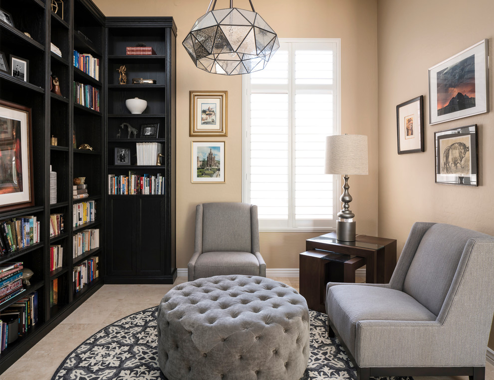 Design ideas for a mid-sized transitional home office in Phoenix with a library, beige walls, travertine floors, no fireplace and beige floor.