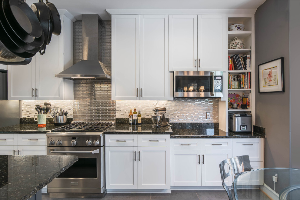 Example of a large trendy u-shaped ceramic tile and gray floor eat-in kitchen design in DC Metro with an undermount sink, shaker cabinets, white cabinets, granite countertops, gray backsplash, porcelain backsplash, stainless steel appliances, an island and black countertops