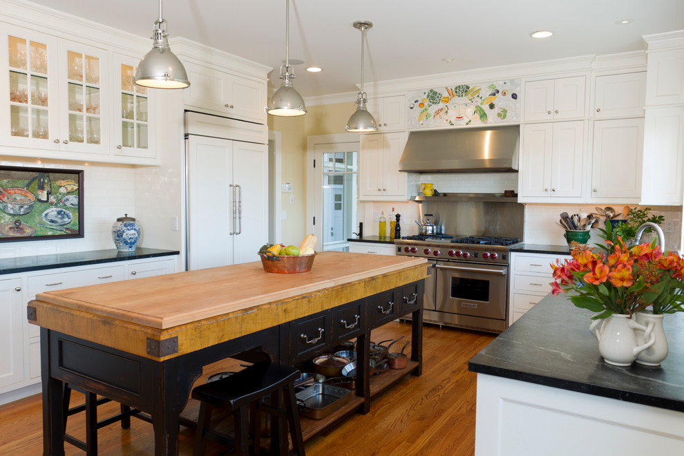 Mid-sized transitional u-shaped medium tone wood floor enclosed kitchen photo in Providence with shaker cabinets, white cabinets, soapstone countertops, white backsplash, subway tile backsplash, stainless steel appliances and an island
