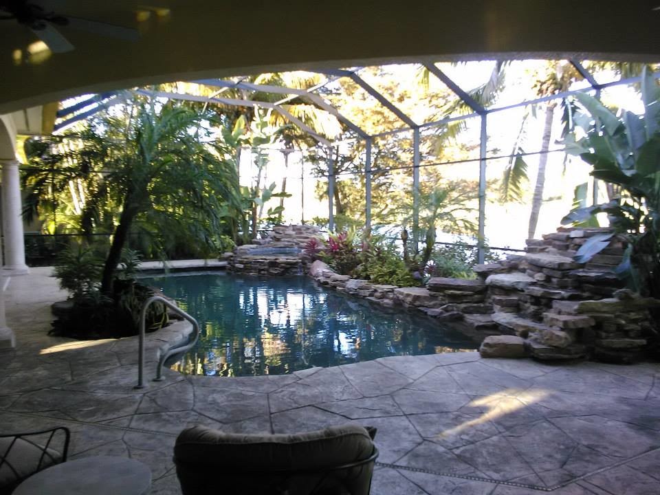 This is an example of a large traditional backyard patio in Miami with concrete slab.