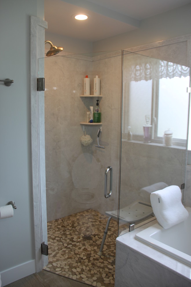 Drop-in bathtub - mid-sized transitional master pebble tile floor and beige floor drop-in bathtub idea with recessed-panel cabinets, gray cabinets, gray walls, a drop-in sink, quartz countertops and a hinged shower door