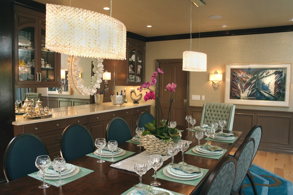 Design ideas for a large traditional separate dining room in Orange County with beige walls and light hardwood floors.