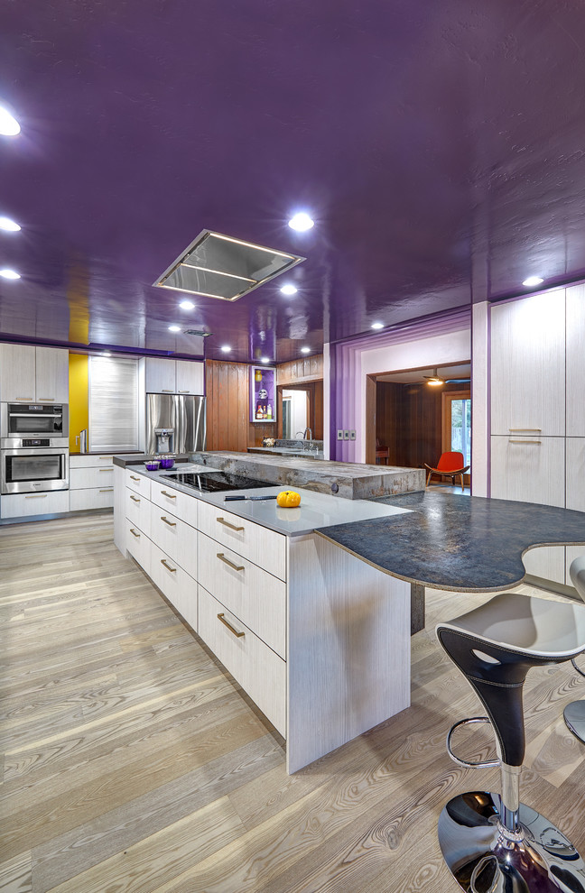 Photo of a large modern l-shaped separate kitchen in Sacramento with an undermount sink, flat-panel cabinets, purple cabinets, quartz benchtops, white splashback, porcelain splashback, stainless steel appliances, light hardwood floors and with island.