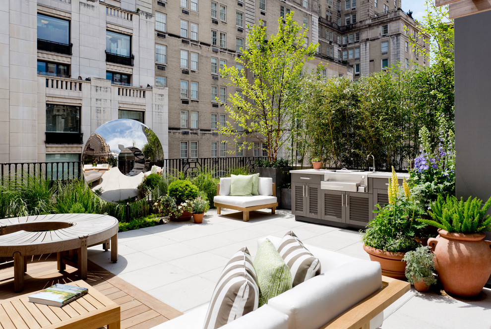 This is an example of a large contemporary rooftop and rooftop deck in New York with an outdoor kitchen and no cover.
