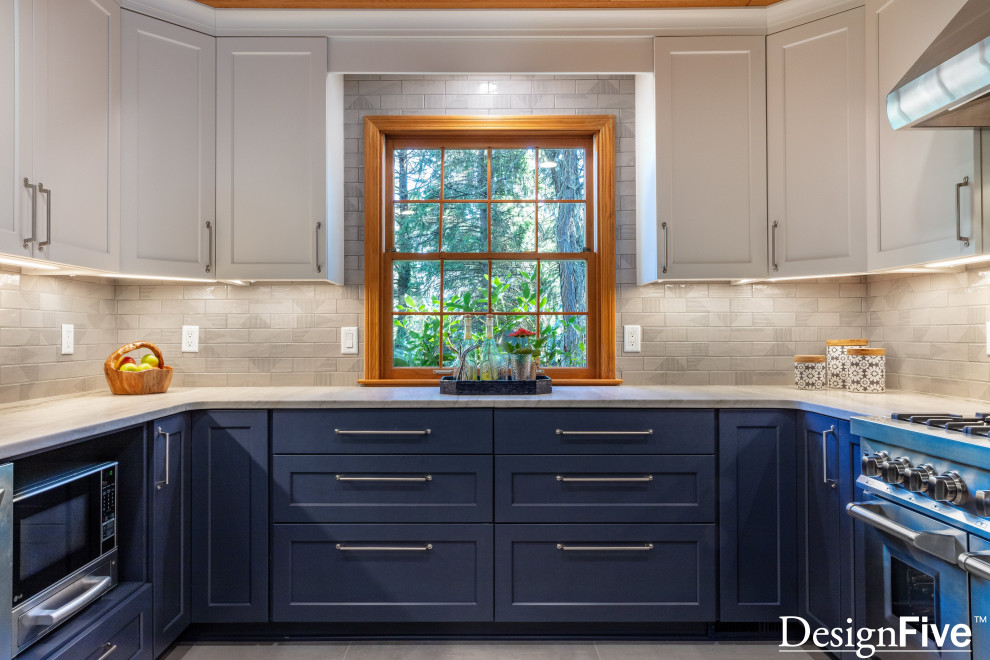 Large minimalist u-shaped gray floor and wood ceiling open concept kitchen photo with an undermount sink, shaker cabinets, blue cabinets, quartz countertops, gray backsplash, ceramic backsplash, stainless steel appliances and no island