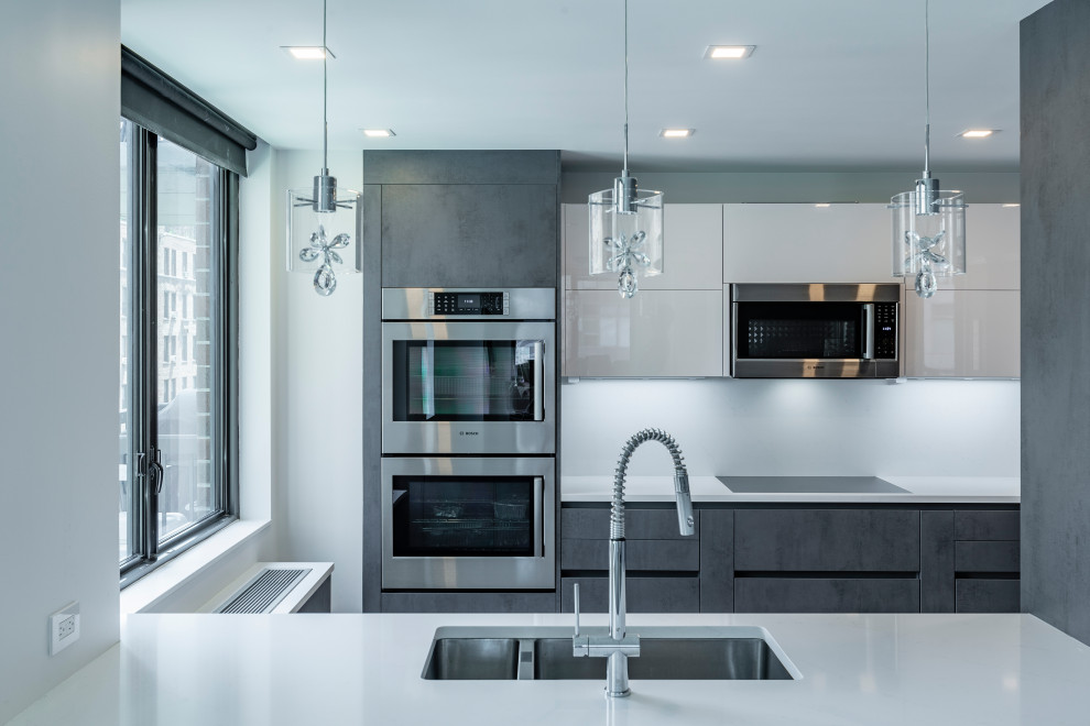 Design ideas for a small modern galley eat-in kitchen in New York with an undermount sink, flat-panel cabinets, grey cabinets, quartz benchtops, white splashback, engineered quartz splashback, panelled appliances, painted wood floors, with island, grey floor and white benchtop.