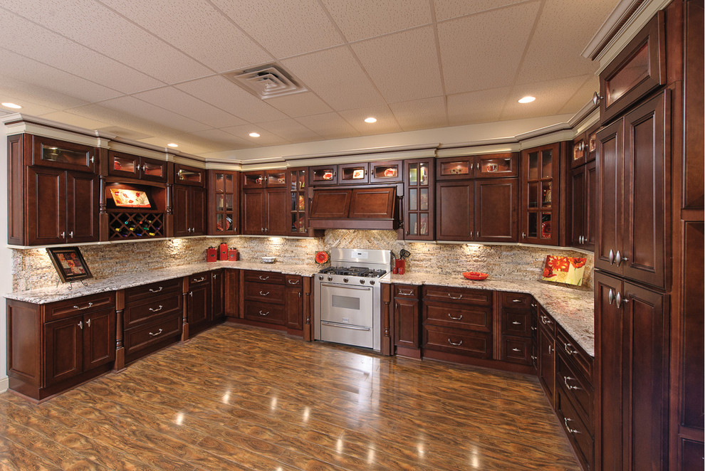 Inspiration for a large transitional l-shaped laminate floor and multicolored floor enclosed kitchen remodel in Orange County with beaded inset cabinets, dark wood cabinets, granite countertops, beige backsplash, stone tile backsplash, stainless steel appliances and no island
