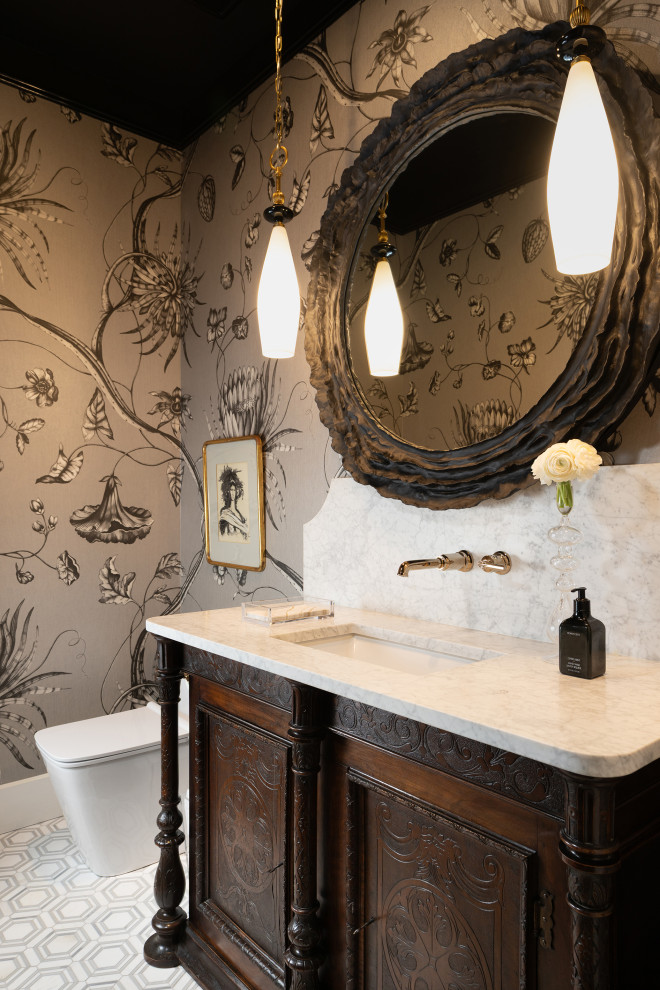 Example of a mid-sized classic powder room design with an undermount sink, marble countertops and a freestanding vanity