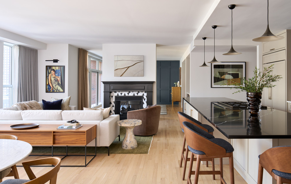 Mid-sized transitional galley open concept kitchen photo in Chicago with recessed-panel cabinets, brown cabinets, quartz countertops, gray backsplash, ceramic backsplash, paneled appliances, an island and black countertops