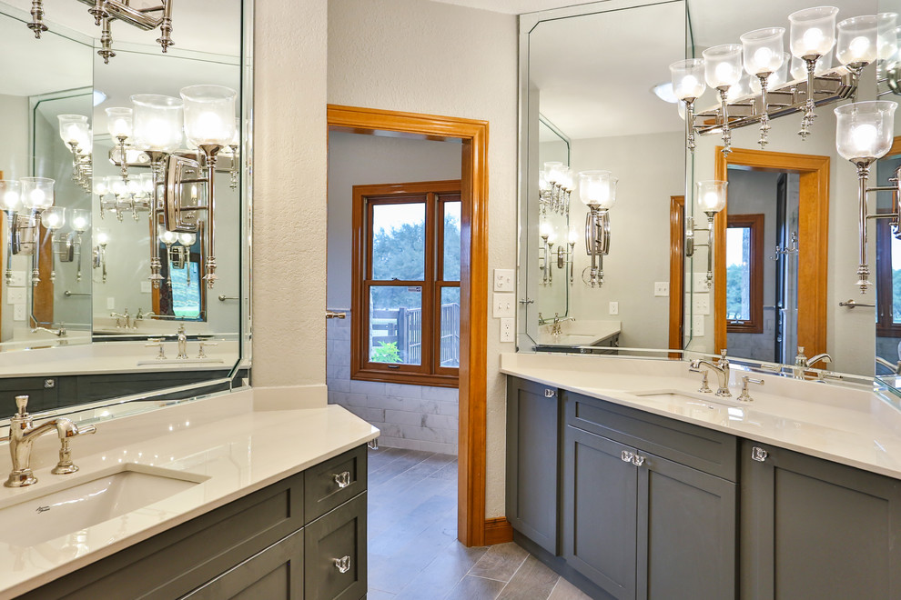Design ideas for a large transitional master bathroom in Austin with shaker cabinets, grey cabinets, a claw-foot tub, an alcove shower, a one-piece toilet, gray tile, marble, an undermount sink, solid surface benchtops, a sliding shower screen and yellow benchtops.