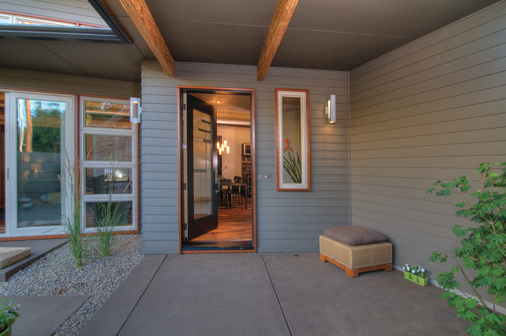 Front door - small transitional concrete floor front door idea with gray walls and a glass front door