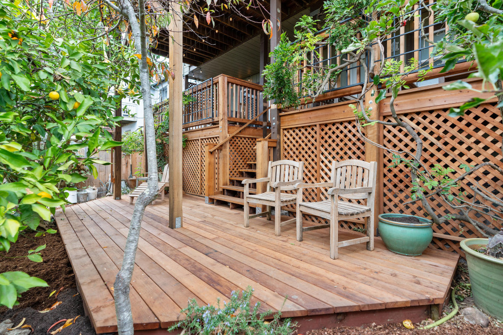 Large mountain style backyard ground level wood railing deck photo in San Francisco with no cover