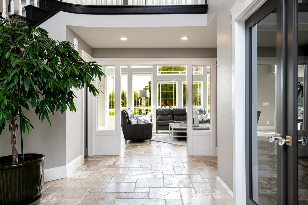 Inspiration for a transitional travertine floor and brown floor single front door remodel in Seattle with gray walls and a black front door