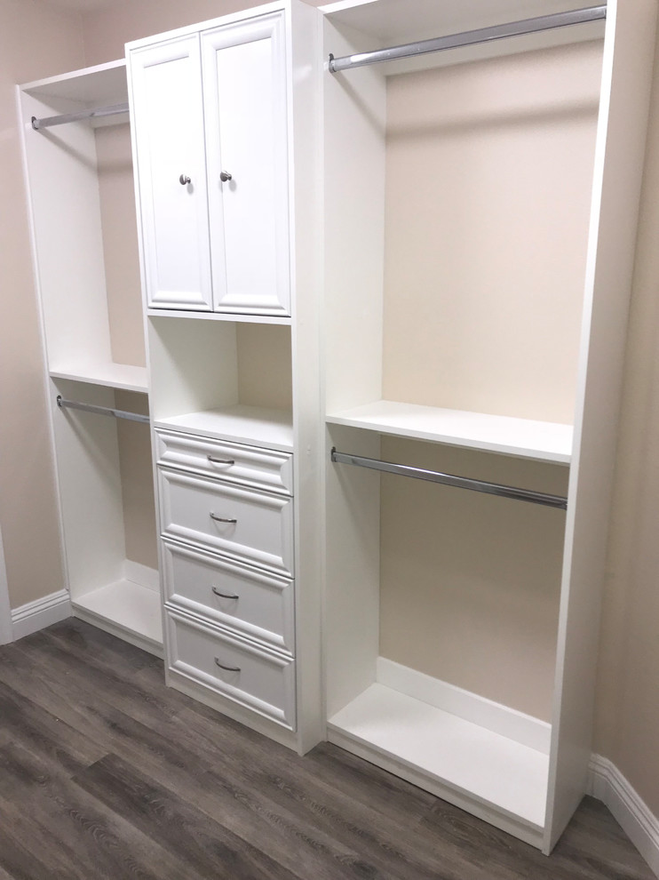 Design ideas for a small traditional gender-neutral walk-in wardrobe in Las Vegas with shaker cabinets, white cabinets, vinyl floors and brown floor.