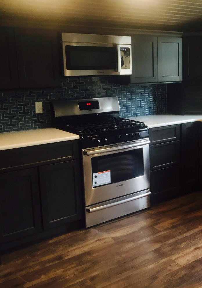 Mid-sized transitional u-shaped light wood floor eat-in kitchen photo in Austin with a double-bowl sink, raised-panel cabinets, black cabinets, soapstone countertops, white backsplash, mosaic tile backsplash, stainless steel appliances and no island