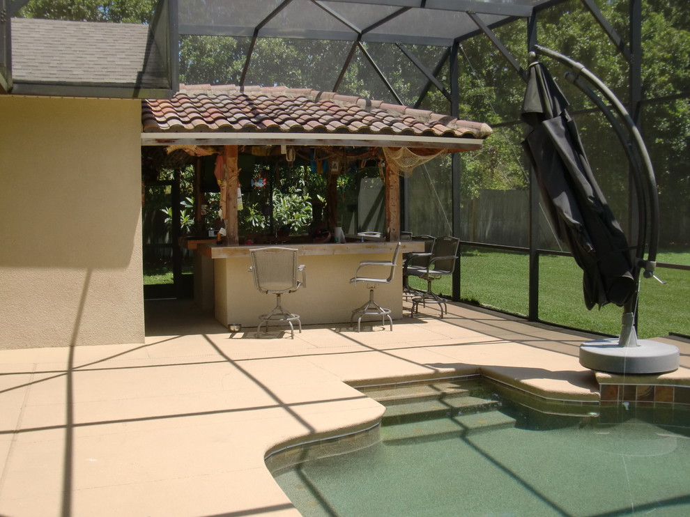 Inspiration for a large beach style backyard patio in Orlando with concrete pavers.